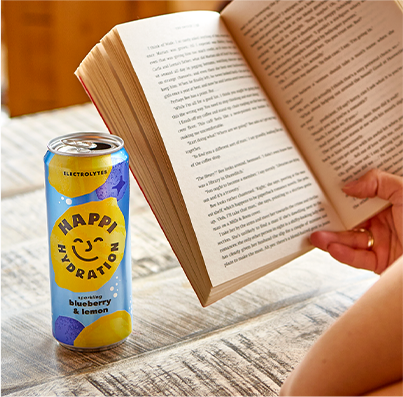 A can of Happi next to an open book